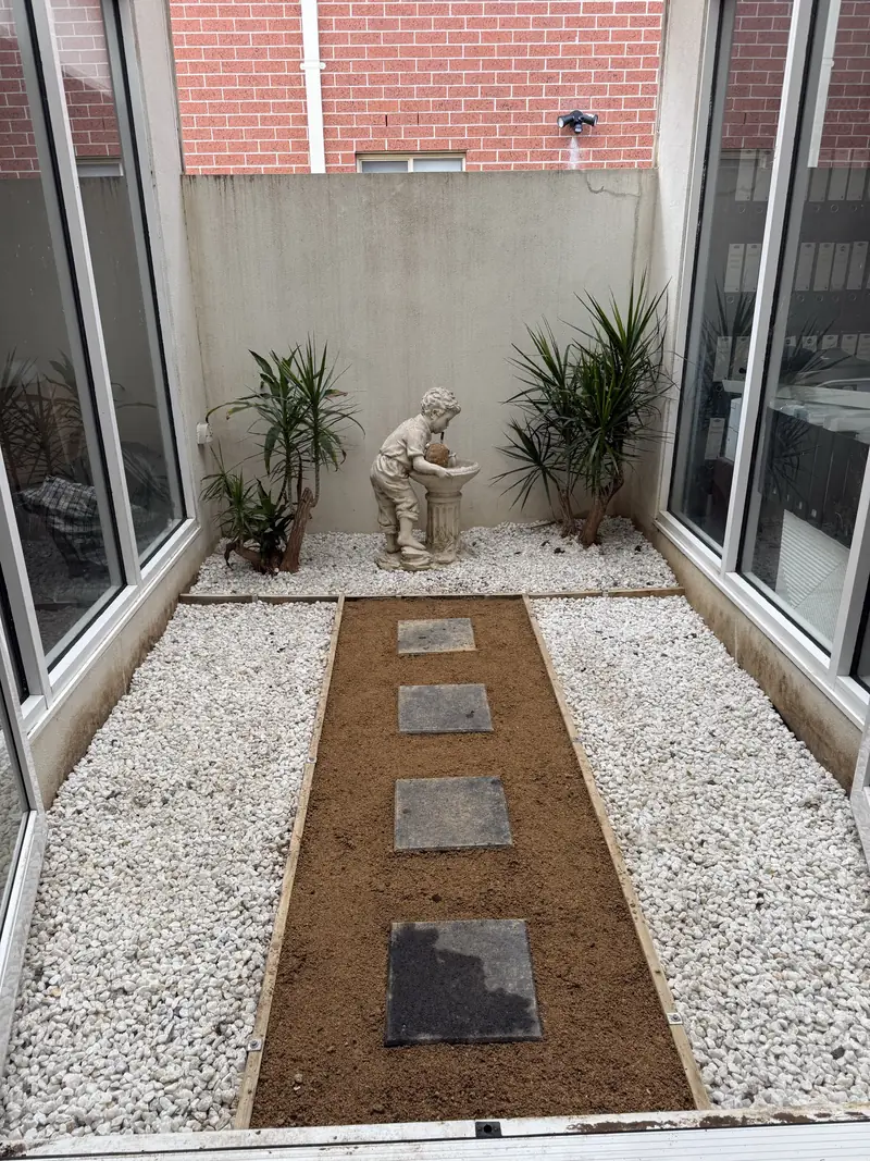 Restored courtyard with stepping stones and gravel