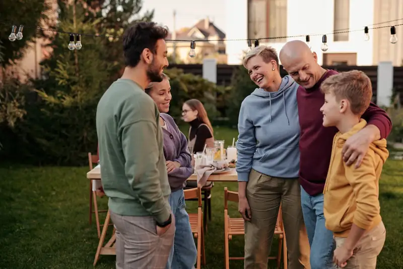 Family and friends catching up in a garden (stock photo)