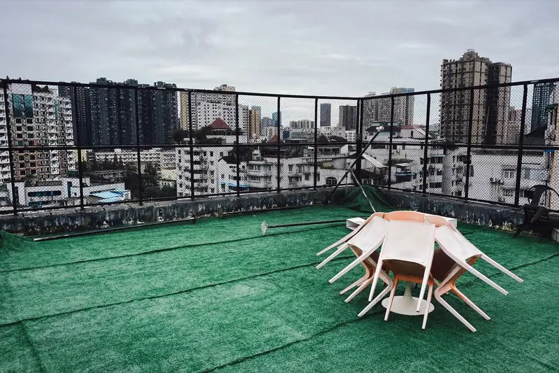 A rooftop terrace laid with artificial turf and an outdoor table (stock photo)
