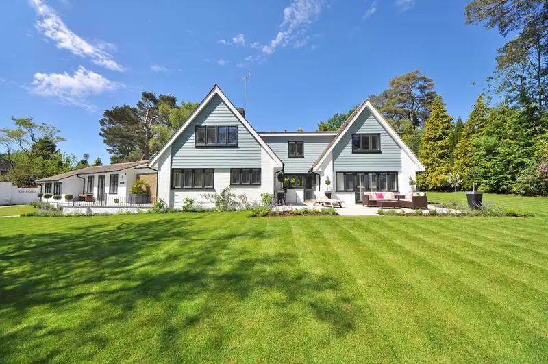 A freshly mown, striped lawn in front of a home (stock photo)