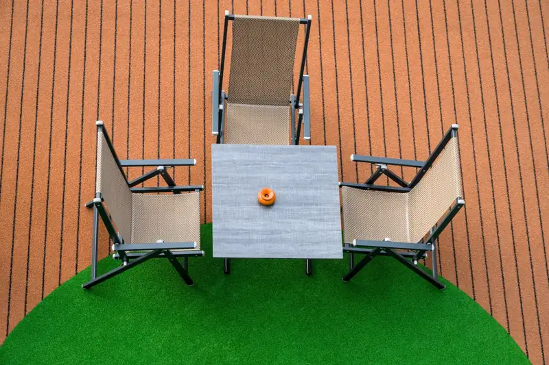 Outdoor table and chairs on artificial turf and decking (stock photo)